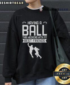 Group of friends enjoying the weekend in a football sweatshirt, having a blast outdoors together, showcasing fun moments.