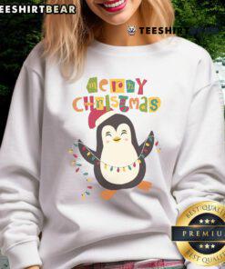 Alt Text: Cute penguin in a Santa hat on a Merry Christmas sweatshirt, perfect for holiday cheer and festive fashion.