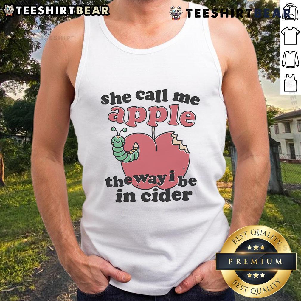 Young woman wearing a 'She Call Me Apple The Way I Be In Cider' tank top, smiling outdoors in a sunny setting.