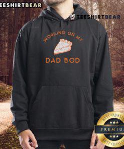 Delicious pie for two beside a cozy 'Working On My Dad Bod' hoodie, perfect for enjoying good eating moments together.