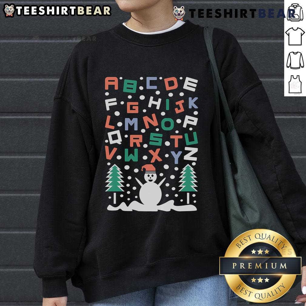 Cozy Good Snowman Alphabet Christmas Sweatshirt featuring a cheerful snowman and festive lettering, perfect for holiday wear.