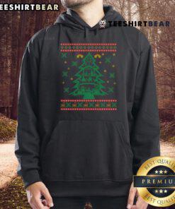 Colorful Christmas nativity scene with a good Christmas tree and a person in an ugly Christmas hoodie celebrating.