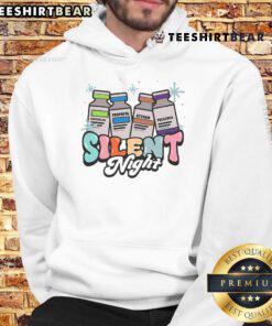 ICU nurse wearing a 'Silent Night' Christmas hoodie in an intensive care unit, celebrating the festive season.
