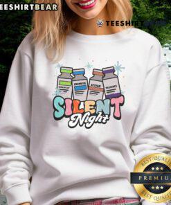 ICU nurse wearing a Christmas sweatshirt featuring 'Silent Night' design, perfect for festive holiday nursing attire.