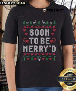 Engaged couple wearing matching ugly Christmas tees, ready for festive celebrations in their cute holiday outfits.