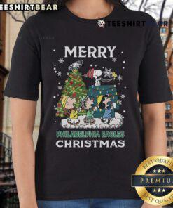 Official Snoopy and Friends Philadelphia Eagles Merry Christmas 2024 ladies tee featuring festive graphics and team spirit.