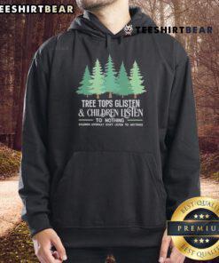 Children in Christmas hoodies listen quietly under glistening tree tops, capturing the magic of the holiday season.