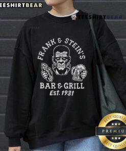 Premium Frank And Steins Bar And Grill funny Halloween party sweatshirt featuring spooky graphics and festive design.