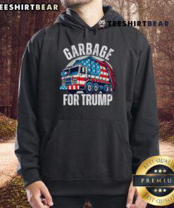 Person wearing a 'Garbage For Trump' hoodie, showcasing support for Trump with a proud expression, in a casual setting.