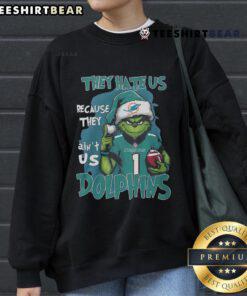 Miami Dolphins sweatshirt featuring 'They Hate Us Because They Ain't Us' slogan, perfect for fans showing team pride.