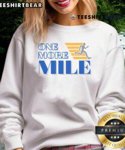 Runner wearing an 'Awesome One More Mile' sweatshirt, showcasing fitness and motivation in a vibrant outdoor setting.