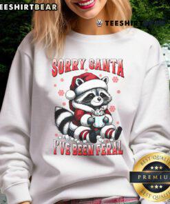 Funny raccoon Christmas sweatshirt with 'Sorry Santa, I've Been Feral' design, perfect for holiday wear.