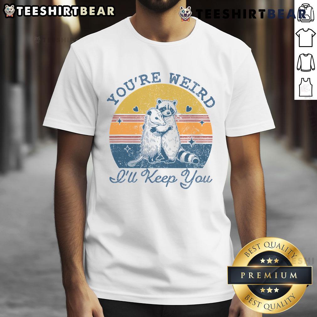 Cute 'You're Weird I'll Keep You' sunset t-shirt featuring vibrant colors and a playful design, perfect for casual wear.