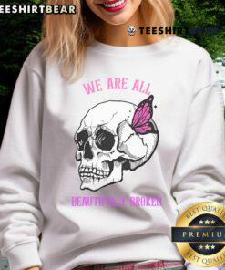 Funny 'We Are All Beautifully Broken' Halloween sweatshirt design featuring playful graphics and autumn colors.