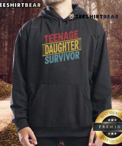 Teenage daughter wearing a retro hoodie, smiling on Father's Day, showcasing love and humor with dad jokes.