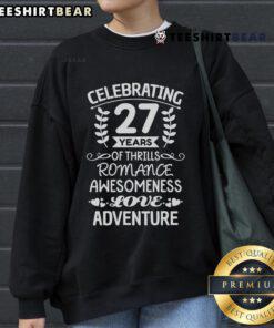 Happy couple in matching sweatshirts celebrating 27 years of love anniversary, showcasing joy and togetherness.