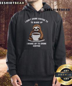 Happy sloth wearing a cozy hoodie while enjoying coffee, showcasing the fun and comfort of the Happy Coffee Drinking Sloth Hoodie.