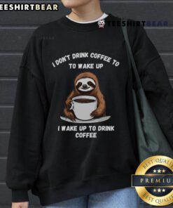 Happy sloth wearing a coffee drinking sweatshirt, showcasing a playful design perfect for cozy coffee lovers.