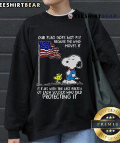 Happy Snoopy and Woodstock on a sweatshirt with 'Our Flag Does Not Fly Because The Wind' design, perfect for fans.
