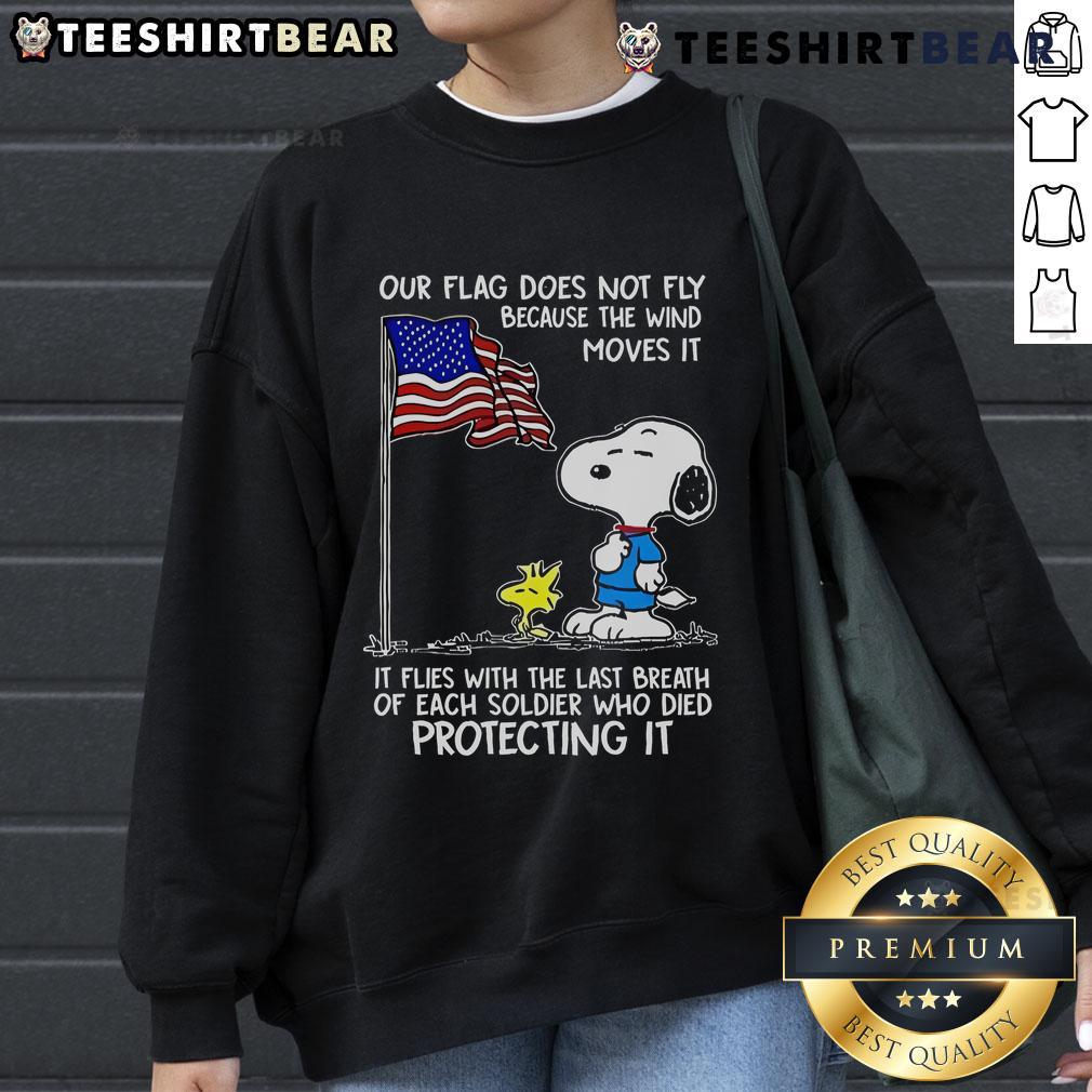 Happy Snoopy and Woodstock on a sweatshirt with 'Our Flag Does Not Fly Because The Wind' design, perfect for fans.