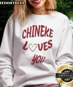 Cozy 'Chineke Loves You' Christmas sweatshirt featuring festive design perfect for holiday celebrations.