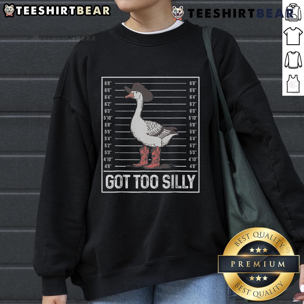 Stylish cowgirl boots paired with a fun 'Silly Goose' sweatshirt, perfect for a trendy country look.