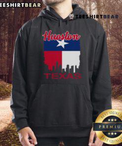Vintage Houston Texas flag hoodie with the vibrant Houston skyline in the background, showcasing city pride and style.