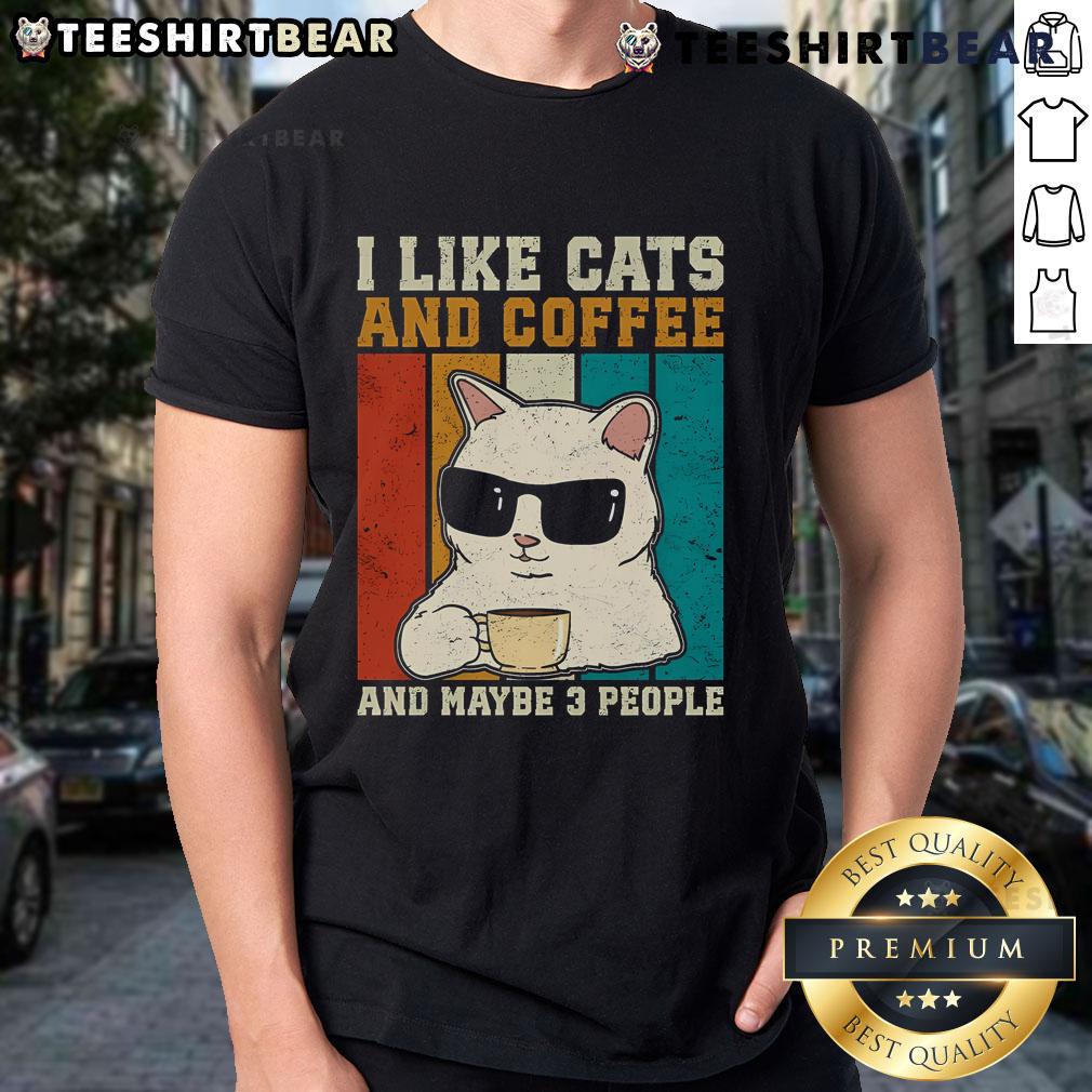 Vintage T-shirt featuring 'I Like Cats And Coffee' with a playful design and three people enjoying coffee and cats.