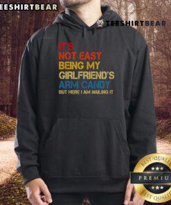 Retro hoodie featuring 'It's Not Easy Being My Girlfriend's Arm Candy' design, perfect for casual style and fun vibes.