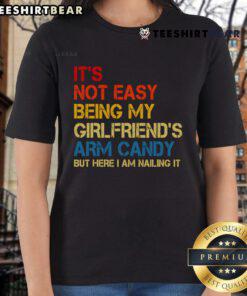 Retro ladies tee featuring 'It's Not Easy Being My Girlfriend's Arm Candy' text, perfect for fun casual wear.