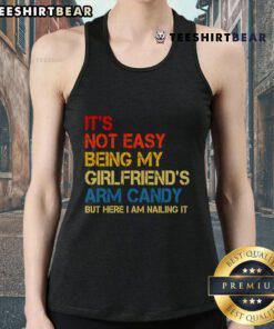 Retro tank top with 'It's Not Easy Being My Girlfriend's Arm Candy' print, perfect for stylish casual wear.