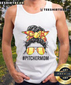 Softball mom in a tank top with a messy bun, cheering for her daughter during a game, showcasing team spirit.