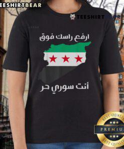 Empowered Syrian women wearing 'Syria is Free' tees, celebrating pride in their freedom and culture in a vibrant setting.