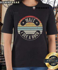 Retro sunset graphic on a ladies tee featuring the phrase 'Nice, Wait, I See a Rock' in vibrant colors.
