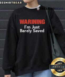 Official Warning sweatshirt with 'I'm Just Barely Saved' printed design, perfect for casual wear and expressing faith.