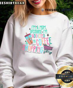 Mom wearing 'Pretty I'm A Mom Of Course I'm Addicted To Coffee And Shopping' sweatshirt, showcasing fun parenting style.