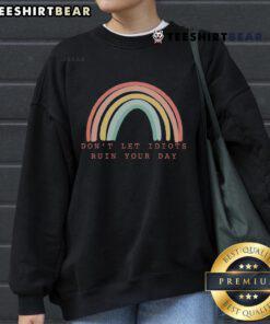 Happy inspirational sweatshirt featuring 'Don't Let Idiots Ruin Your Day' with a vibrant rainbow design.