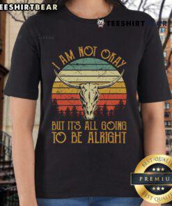 Vintage sunset ladies tee featuring 'I'm Not Okay But It's Going To Be Alright' text in a country music style.