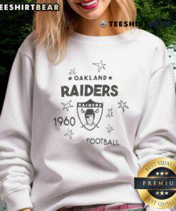 Alt Text: Stylish Top Oakland Raiders logo sweatshirt featuring black and white design, perfect for fans and cold weather.