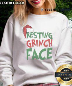 Cozy Christmas sweatshirt featuring a playful Grinch face design, perfect for holiday festivities and winter wear.