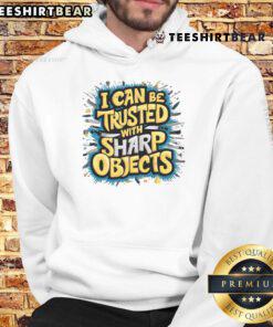 Funny hoodie featuring 'I Can Be Trusted With Sharp Objects' design, perfect for humor lovers and unique fashion enthusiasts.