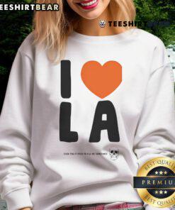 Funny 'I Love LA Even Though It Tries to Kill Me Sometimes' sweatshirt design featuring vibrant colors and playful typography.