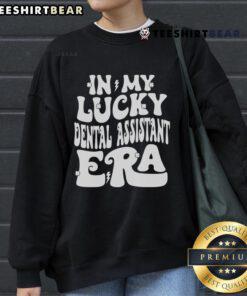 St. Patrick's Day shamrock sweatshirt featuring 'Good In My Lucky Dental Assistant Era' text for festive dental professionals.