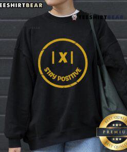Positive math teacher wearing 'Stay Positive' sweatshirt, promoting a love for math and avoiding negativity in education.