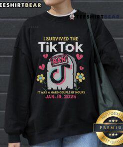 Cozy sweatshirt featuring 'Hot I Survived The TikTok Ban' text, perfect for TikTok fans who love humor and style.