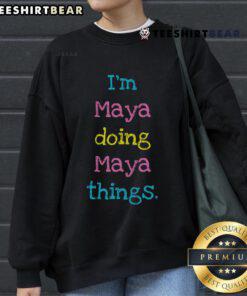 Maya wearing a cozy 'Nice Im Maya Doing Maya Things' sweatshirt, showcasing a fun and relaxed style.