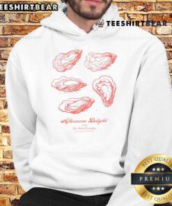 Enjoying a nice oyster afternoon delight at Hotel Paradiso, featuring a cozy hoodie and a picturesque seaside view.