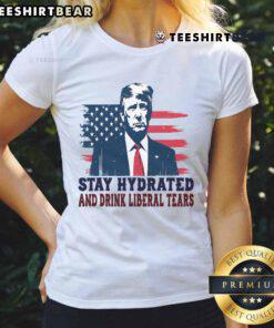 Funny 'Stay Hydrated by Liberal Tears' tee for Trump supporters, featuring USA flag design. Perfect for patriotic ladies.