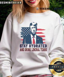 Funny sweatshirt for Trump supporters featuring 'Stay Hydrated by Liberal Tears' with USA flag design.