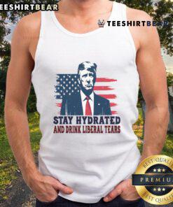 Trump supporters wearing a tank top with 'Stay Hydrated By Liberal Tears' design, featuring the USA flag.